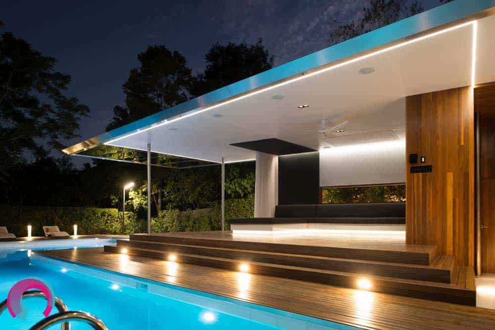 Exterior, residential pool pavilion showing the lap pool and the architecturally designed pavilion leading down to the pool deck